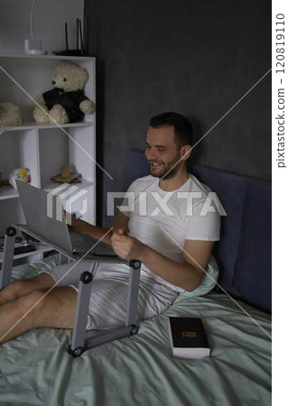 30-year-old man with a Bible attends an online church service, talks with the pastor 120819110