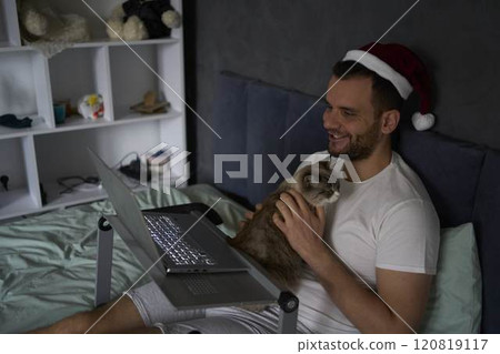 30-year-old man celebrates Christmas and the New Year online with colleagues and friends 120819117