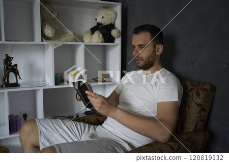 a 30-year-old man with a Bible attends an online church service, talks with the pastor 120819132