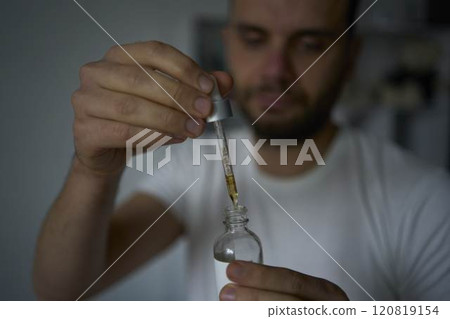 30-year-old man applies a beard growth product 120819154