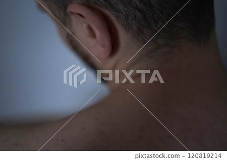 A 30-year-old man massages his neck to relieve pain A 30-year-old man massages his neck to relieve pain 120819214