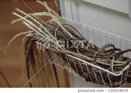 Artificial pigtails as a blank for a hairstyle in a hairdressing salon in a basket, close-up. Artificial pigtails as a blank for a hairstyle in a hairdressing salon in a basket, close-up. 120819630