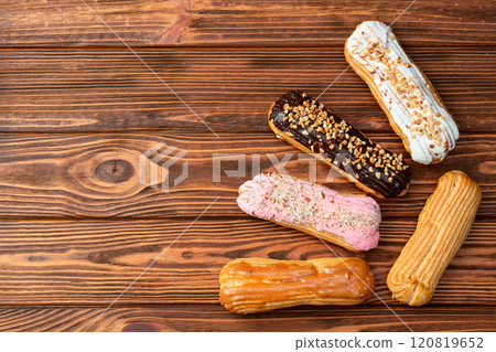 Assorted eclairs on a pastel top view Traditional French dessert 120819652