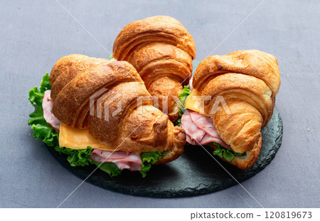 Croissant sandwich with salad ham and cheese . Top view 120819673