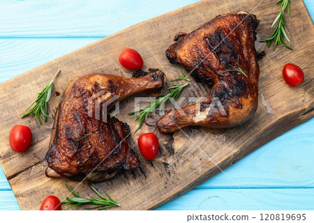 Grilled chicken legs with tomatoes and salad . Top view 120819695