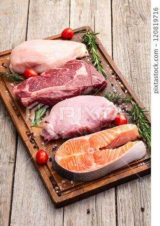 Mix of raw meat and fish . Salmon , beef , pork , chicken staek . Top view 120819716