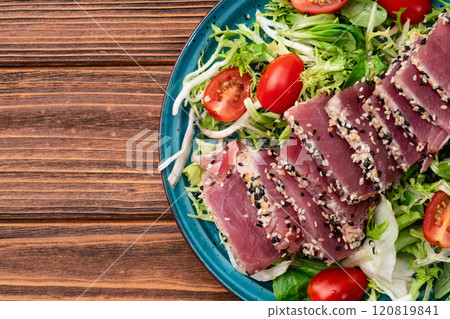 Salad with raw tuna , sesame and cherry tomatoes photography . Top view Salad with raw tuna , sesame and cherry tomatoes photography . Top view 120819841