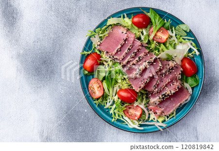 Salad with raw tuna , sesame and cherry tomatoes photography . Top view Salad with raw tuna , sesame and cherry tomatoes photography . Top view 120819842