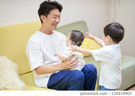 Middle-aged man playing with children 120819905