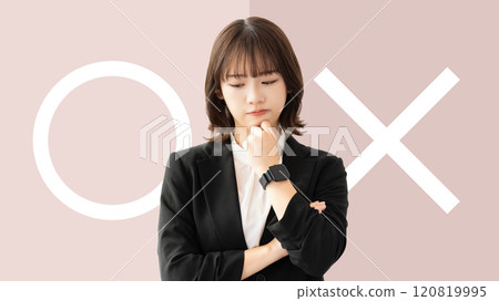A woman/businesswoman thinking about whether to pass or fail 120819995