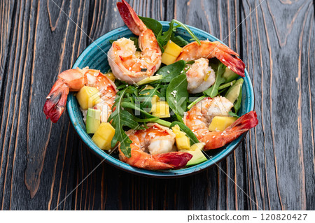 Salad with tiger shrimps , avocado and mango . Top view 120820427
