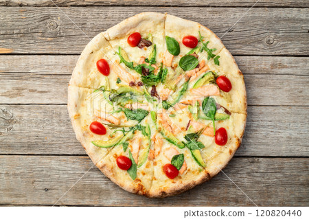 Italian pizza with avocado salmon tomatoes and mozzarella photography. top view Italian pizza with avocado salmon tomatoes and mozzarella photography. top view 120820440