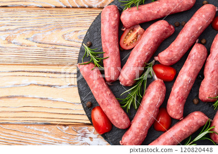 Raw beef sausages with rosemary and tomatoes photography . Top view 120820448