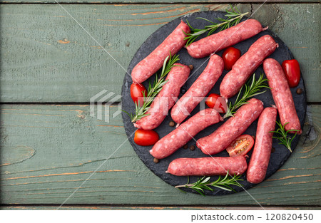 Raw beef sausages with rosemary and tomatoes photography . Top view Raw beef sausages with rosemary and tomatoes photography . Top view 120820450