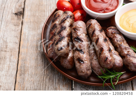 Grilled beef sausages with rosemary sauce and tomatoes photography . Top view 120820458