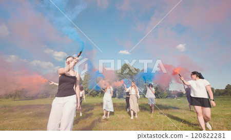 Group of students people are walking in a field, having fun with colored smoke. Group of students people are walking in a field, having fun with colored smoke. 120822281