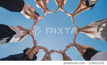 Group of friends forming star shape with hands together 120822282