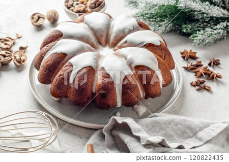 Christmas gingerbread cake glazed on white table with fir branches. Christmas festive dessert, homemade holiday baking recipe 120822435