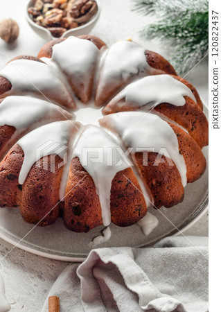 Christmas gingerbread cake glazed on white table with fir branches. Christmas festive dessert, homemade holiday baking recipe Christmas gingerbread cake glazed on white table with fir branches. Christmas festive dessert, homemade holiday baking recipe 120822437