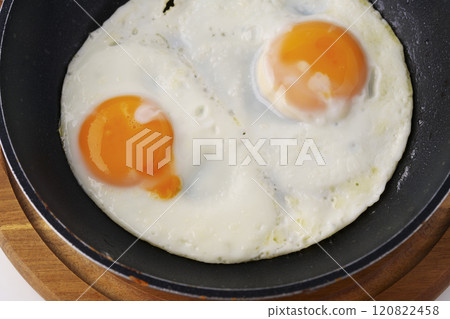 Fried eggs in a frying pan 120822458