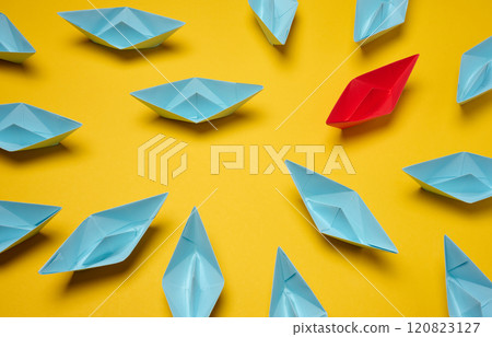 A group of blue paper boats surrounded one red boat, the concept of bullying A group of blue paper boats surrounded one red boat, the concept of bullying 120823127