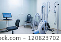 A respiratory therapy room equipped with a pulmonary function test machine, nebulizers, and oxygen therapy equipment. The room features a patient examination chair 120823702