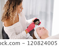 Aesthetician prepares a custom cleansing solution, carefully mixing ingredients for an effective skin treatment. 120824005