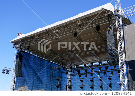 Fragment of metal trusses, lighting and sound system elements of a large outdoor concert stage Fragment of metal trusses, lighting and sound system elements of a large outdoor concert stage 120824141