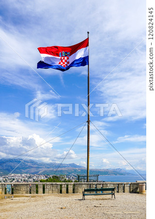 A large Croatian flag flies on a high mast on a Marjan hill viewpoint above the city of Split 120824145