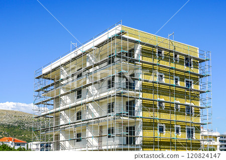 Thermal insulation works of the facade of a apartment building with mineral wool plates 120824147