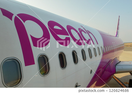 Low cost Peach Aviation planes on the runway of Kansai International Airport, artificial island in Osaka Bay in Osaka, Japan Low cost Peach Aviation planes on the runway of Kansai International Airport, artificial island in Osaka Bay in Osaka, Japan 120824686