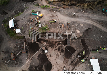 A stone quarry in Indonesia. Large equipment such as bulldozers and dump trucks are working on the site. A stone quarry in Indonesia. Large equipment such as bulldozers and dump trucks are working on the site. 120825020