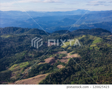 Lush green hills and mountainous landscape in daylight showing deforestation effects 120825423