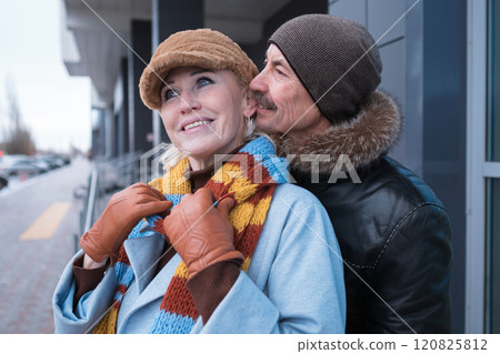 Happy senior couple smiling outdoors in winter clothes Happy senior couple smiling outdoors in winter clothes 120825812