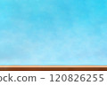 A brown wooden table in front of a blurred blue background 120826255