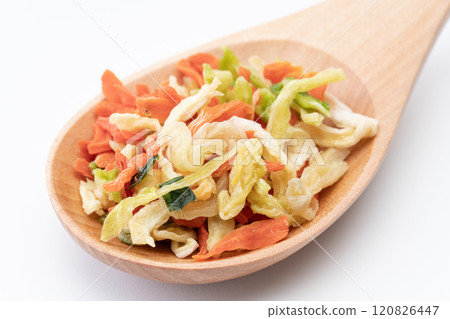Mix of dried vegetables for topping on a wooden spoon 120826447