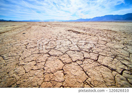 Cracked Desert Earth Under Blue Sky Eye Level Perspective 120826810