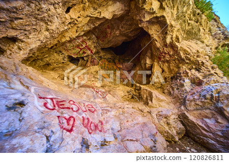 Cave Graffiti Jesus Loves You Amidst Rugged Rocks Low Angle View 120826811