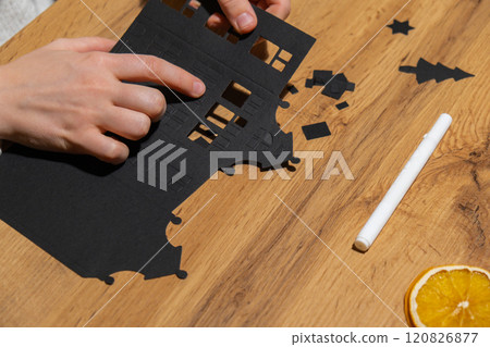 Gingerbread paper house handmade Storytelling creating craft Christmas holiday decoration. Tactile hand-on activity. Master class progress of creative me-made gifts. Seasonal domestic life micro 120826877