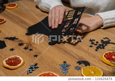 Gingerbread paper house handmade Storytelling creating craft Christmas holiday decoration. Tactile hand-on activity. Master class progress of creative me-made gifts. Seasonal domestic life micro 120826878