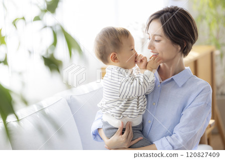 Mom and baby relaxing on the sofa 120827409