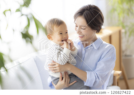 Mom and baby relaxing on the sofa Mom and baby relaxing on the sofa 120827422