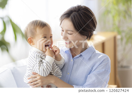 Mom and baby relaxing on the sofa 120827424