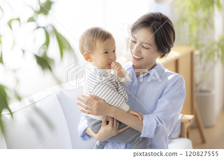 Mom and baby relaxing on the sofa Mom and baby relaxing on the sofa 120827555