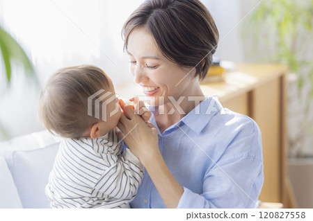 Mom and baby relaxing on the sofa Mom and baby relaxing on the sofa 120827558