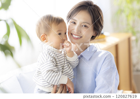 Mom and baby relaxing on the sofa Mom and baby relaxing on the sofa 120827619