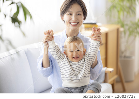 Mom and baby relaxing on the sofa 120827722