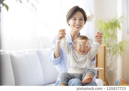 Mom and baby relaxing on the sofa 120827723