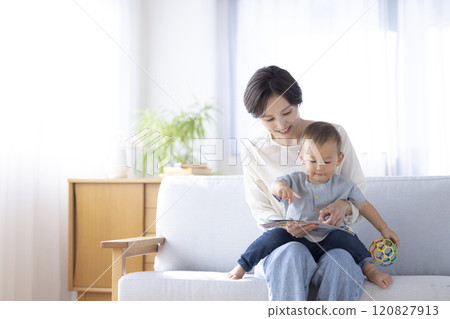Mom and baby relaxing on the sofa 120827913