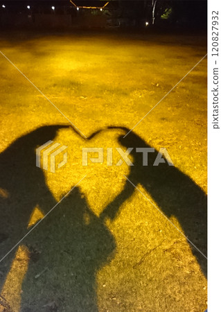 Three women playing with heart shadows in the park Three women playing with heart shadows in the park 120827932